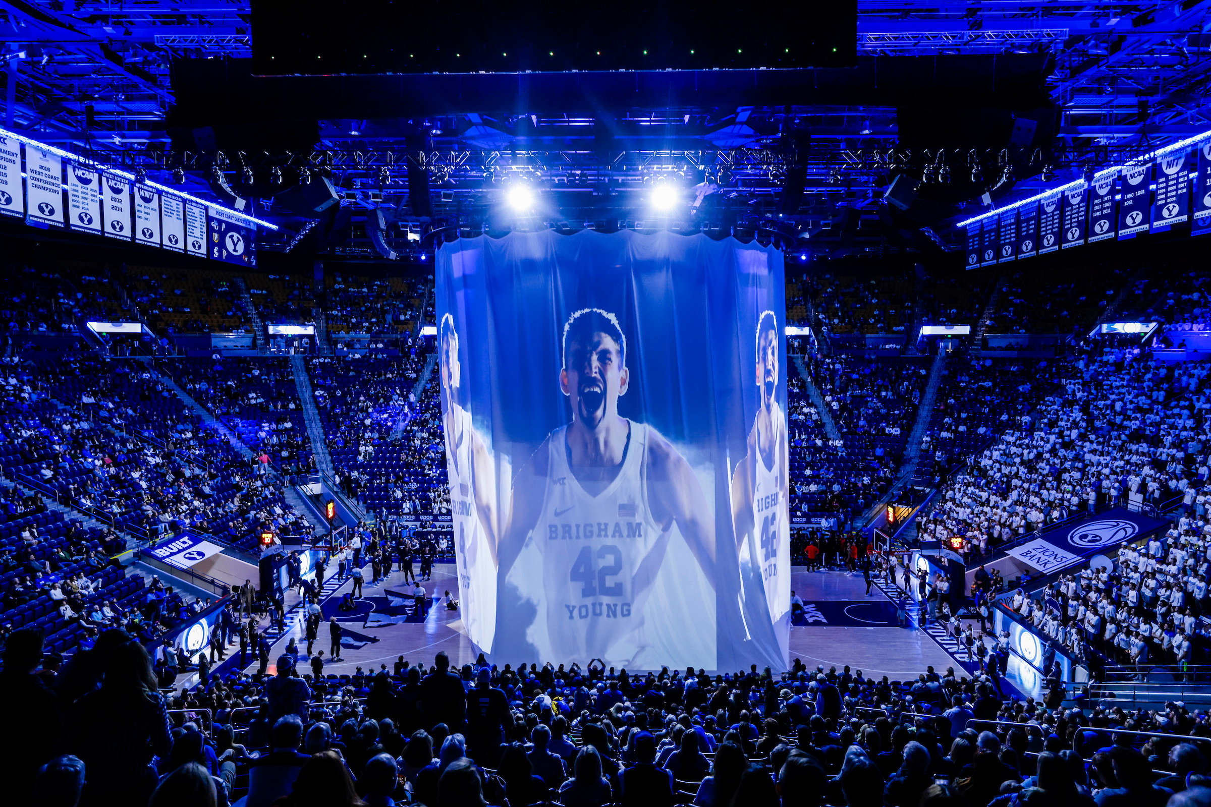 Wide shot of Marriott Center pregame with a Richard Harward projected on the sheet drop