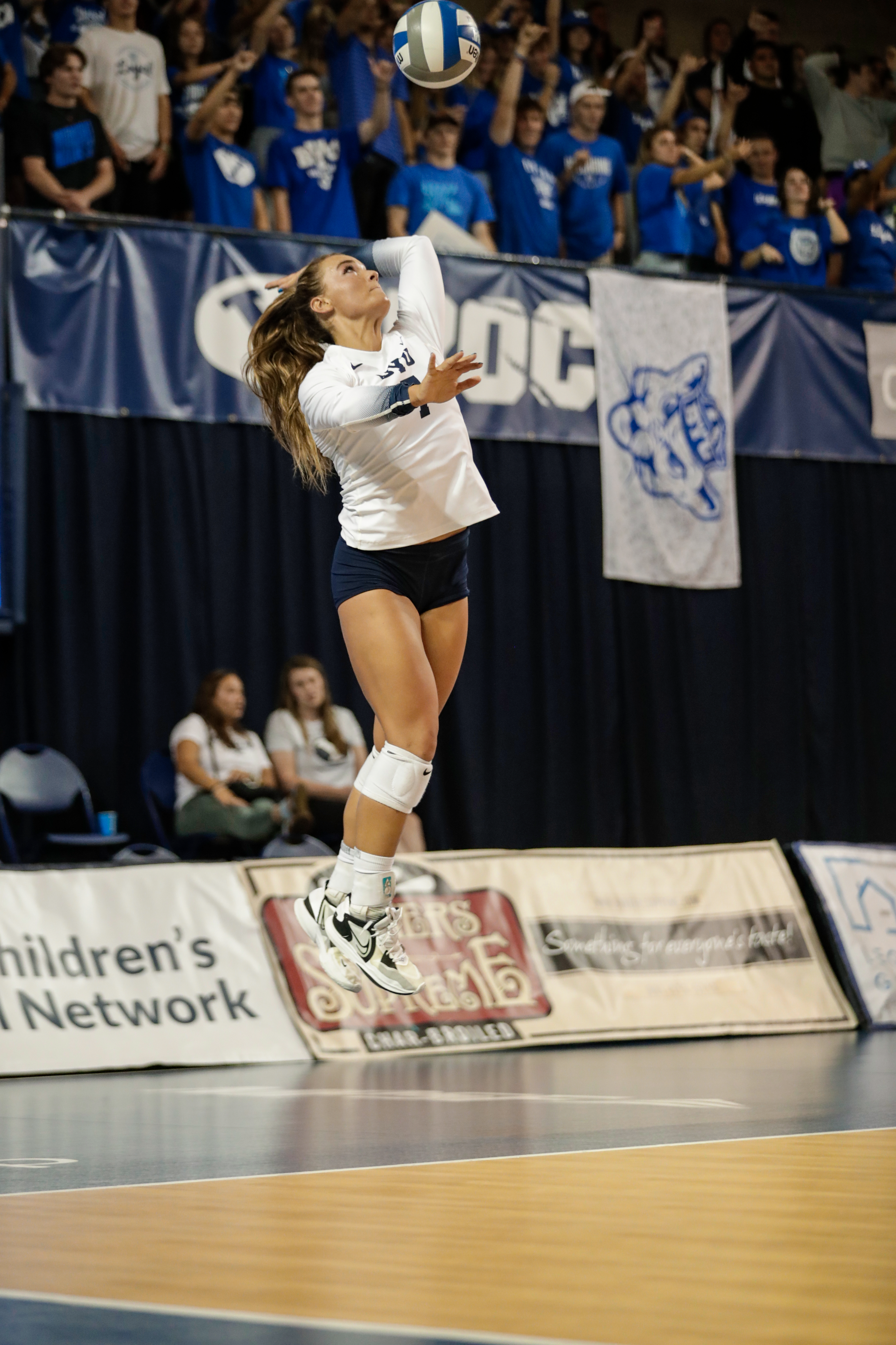 Whitney Bower serves during a game against LMU.