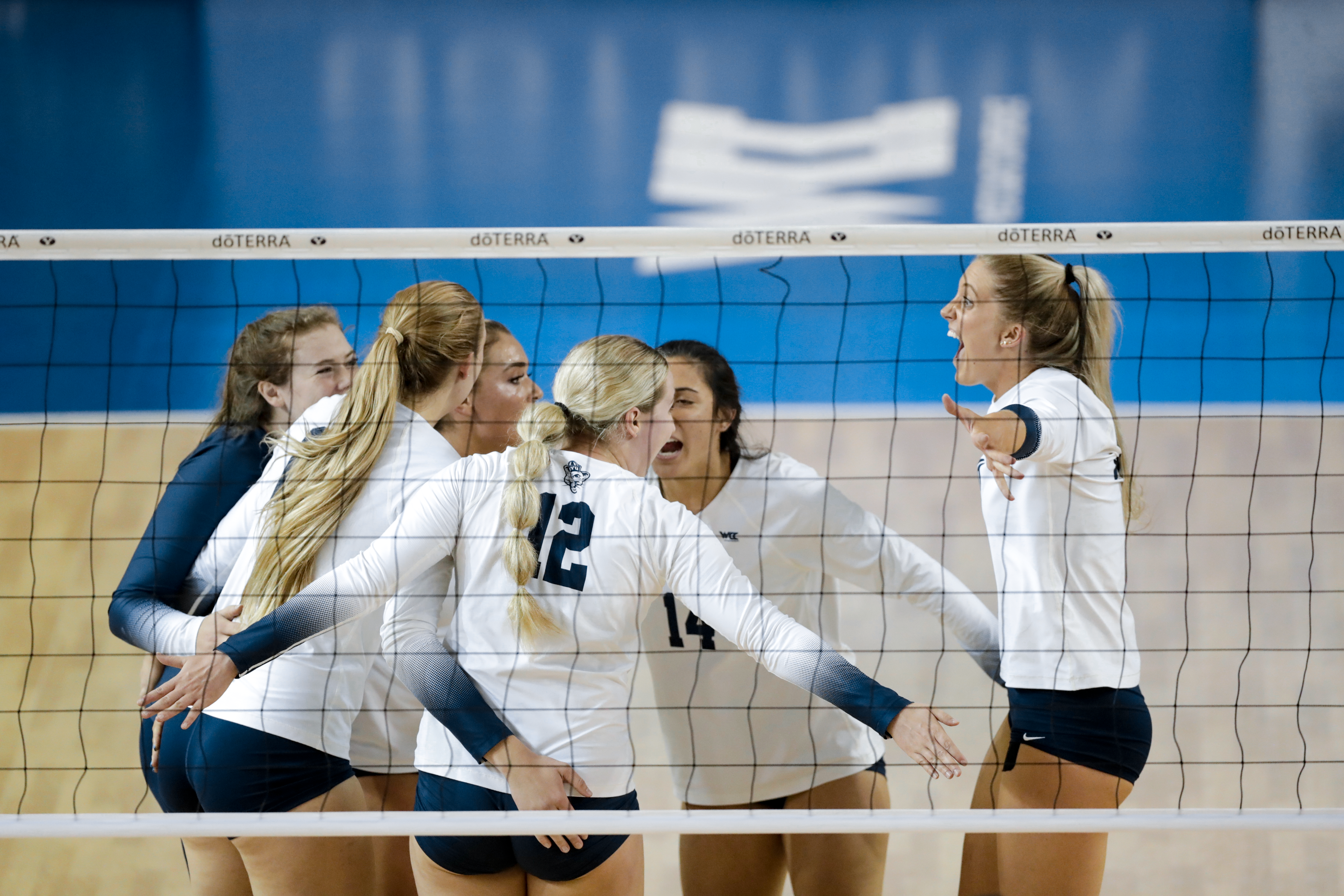 BYU women's volleyball celebrates after scoring a point during a game against LMU.