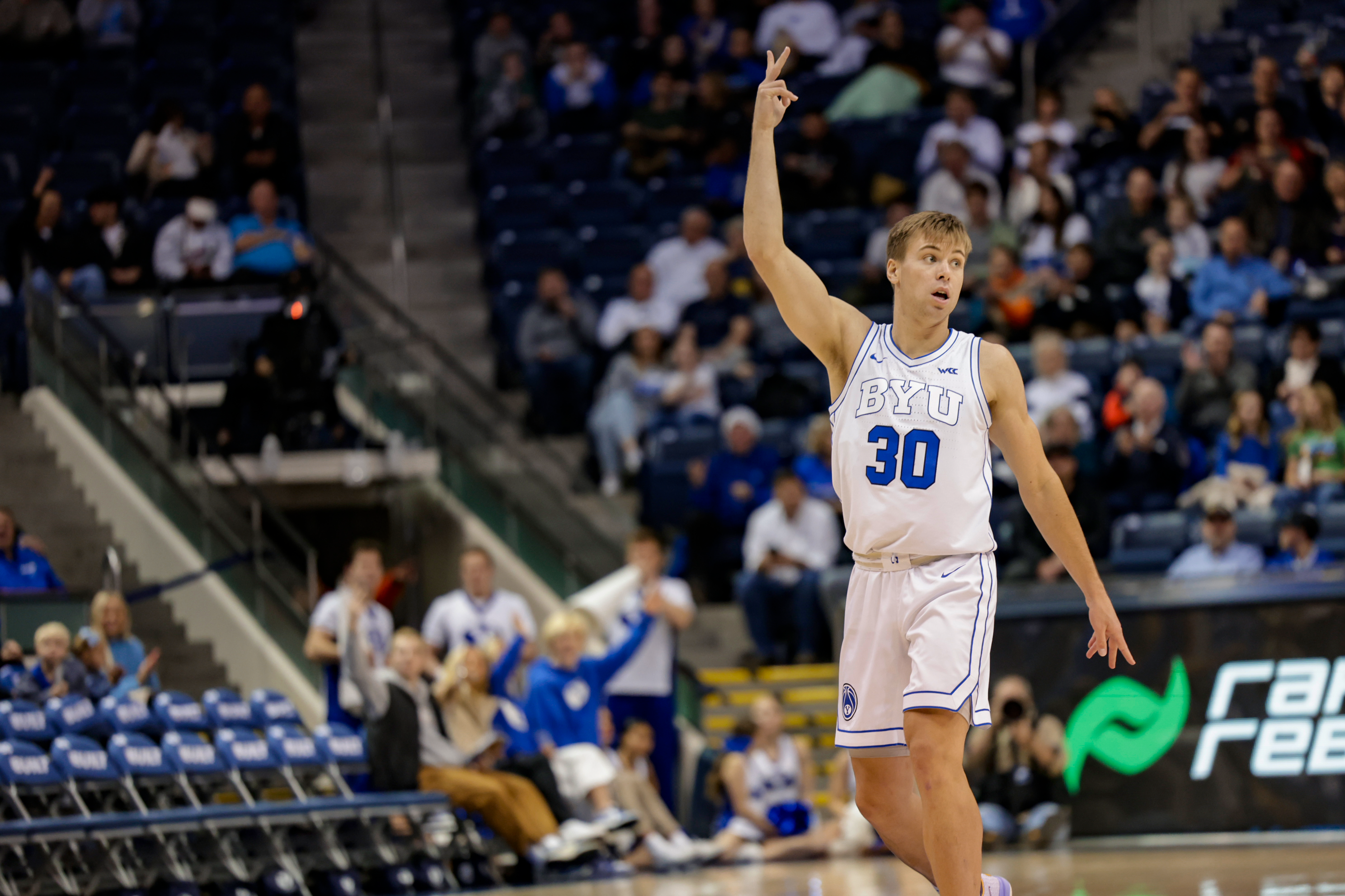 Dallin Hall celebrates after hitting a three during a game against Western Oregon at the Marriott Center.