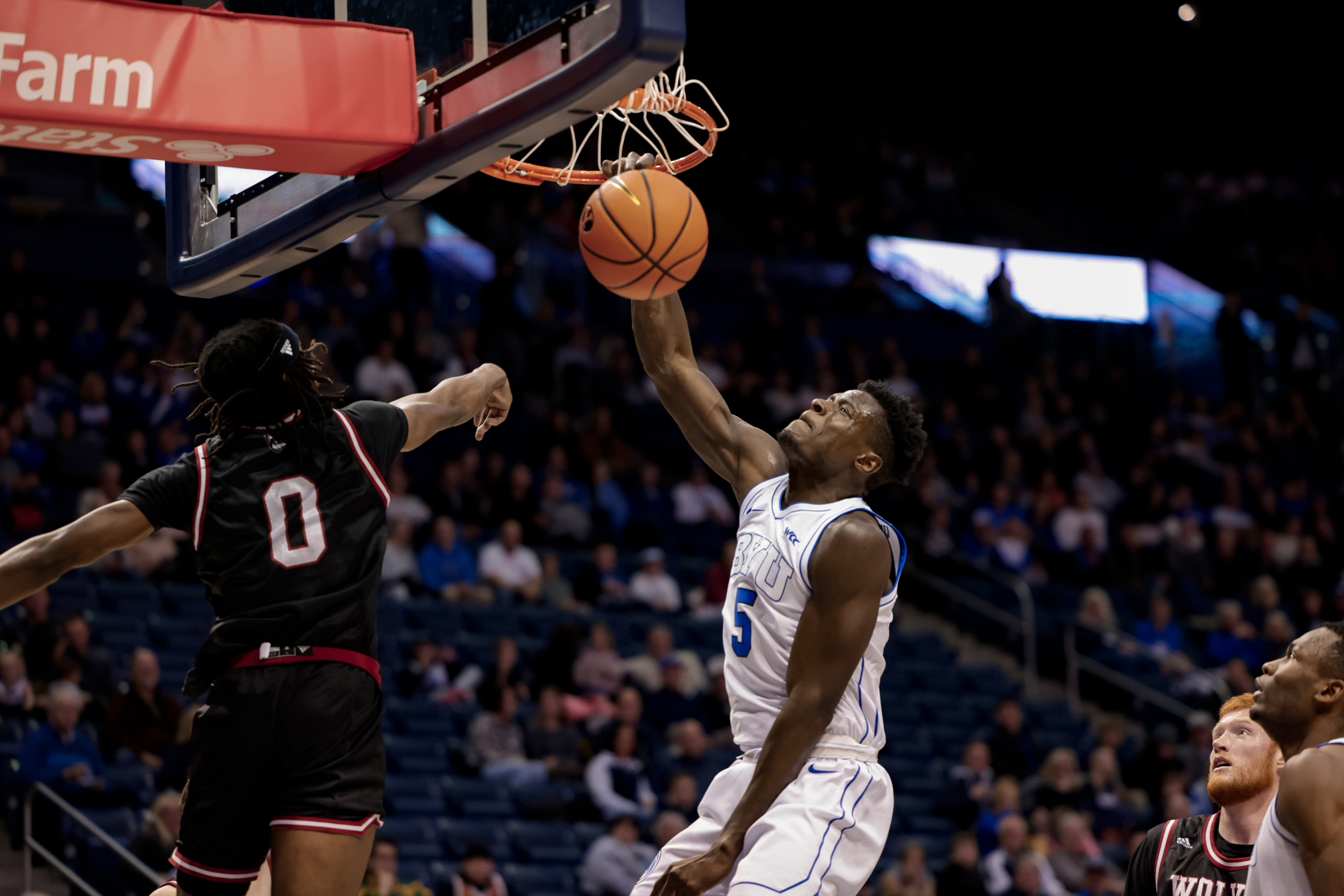 Gideon George throws down a tomahawk jam during a game against Western Oregon at the Marriott Center.