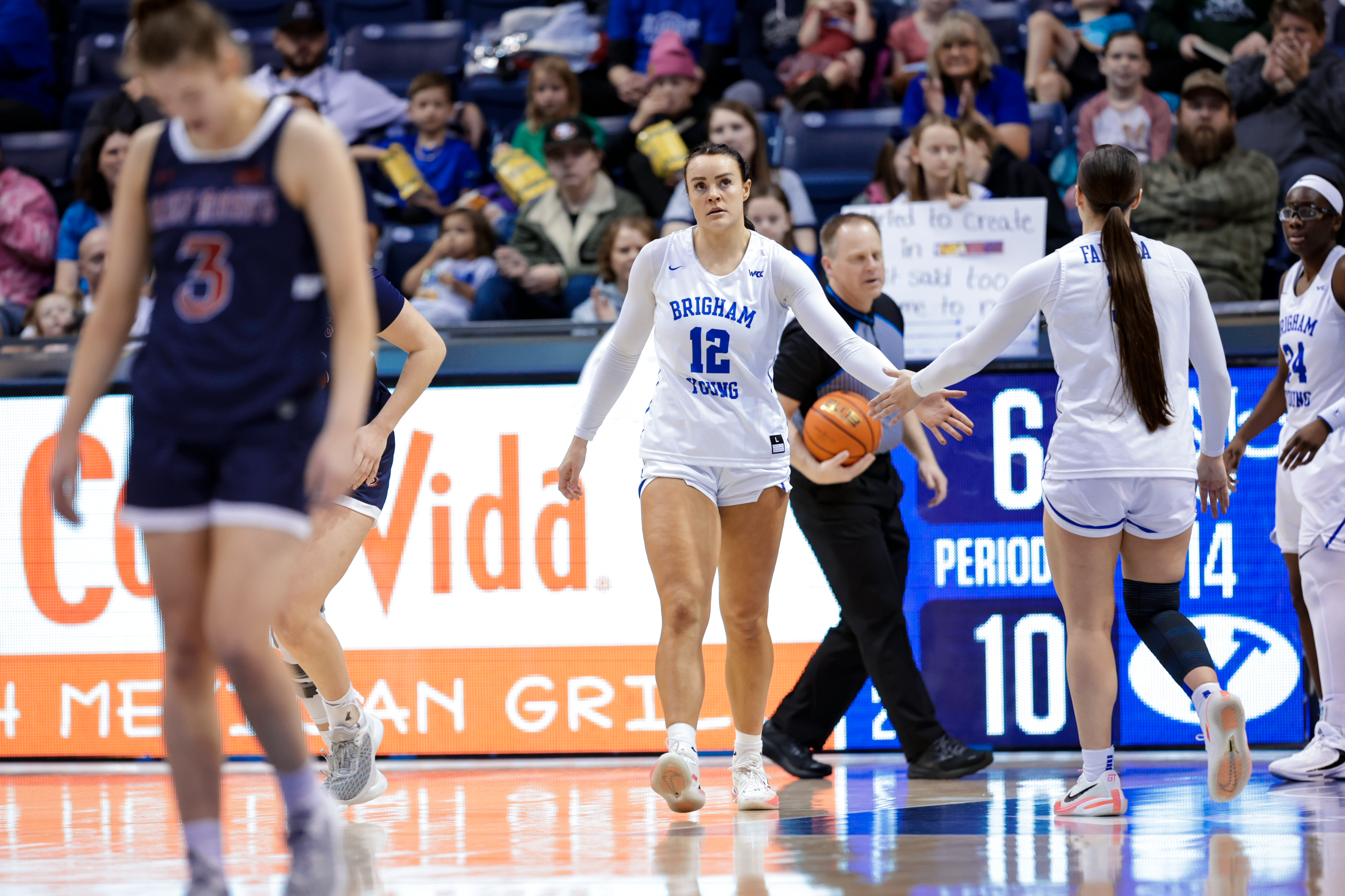 Lauren Gustin and Nani Falatea hits a shot during a game against Saint Mary's at the Marriott Center.