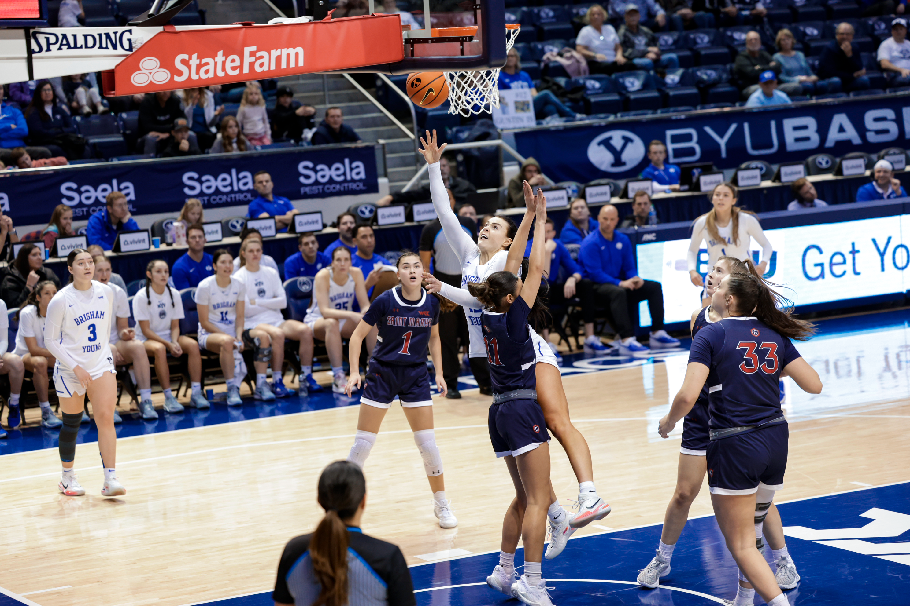 Lauren Gustin scores over a Saint Mary's defender in a game at the Marriott Center.