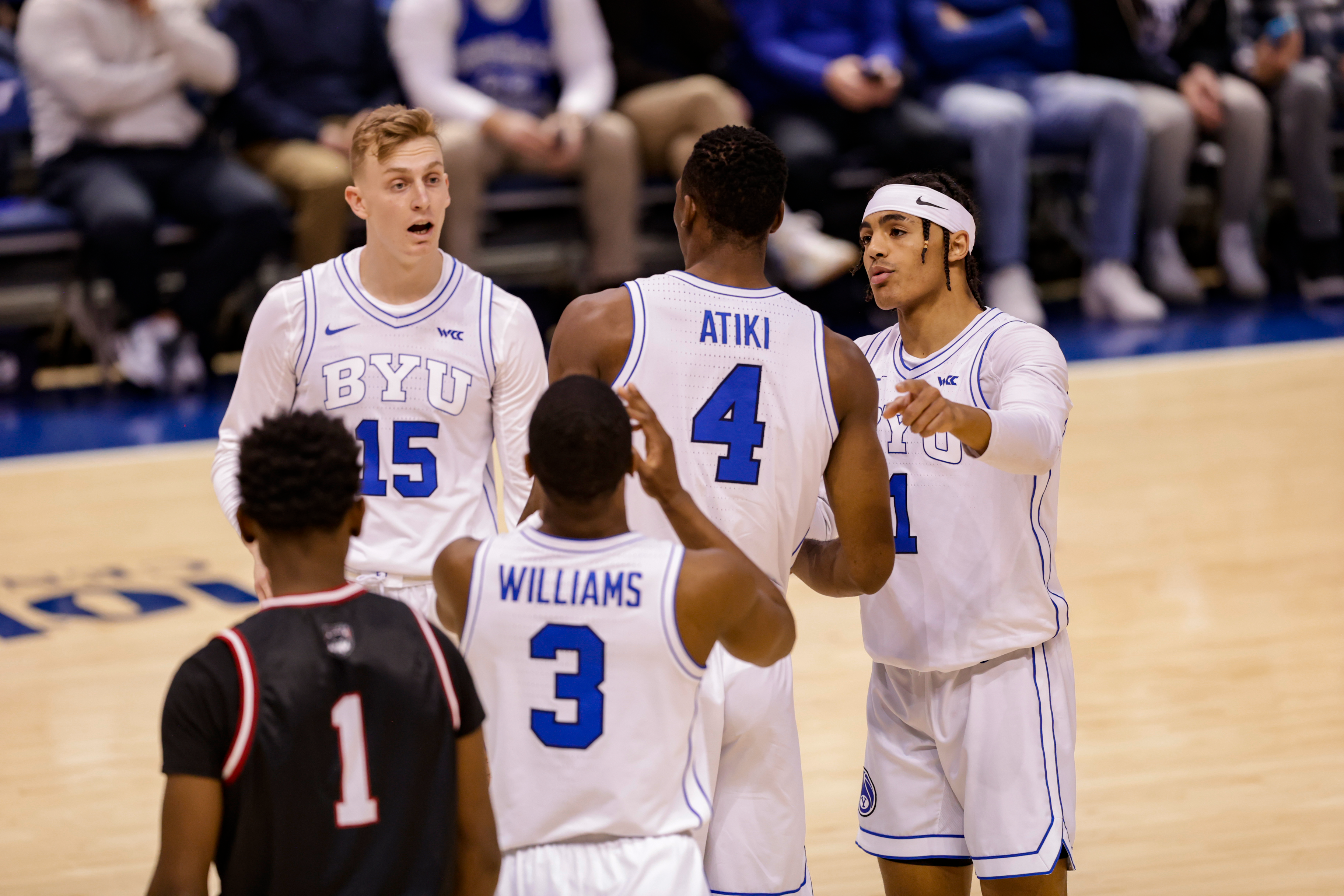The team meets between free throws during a game against Western Oregon at the Marriott Center.