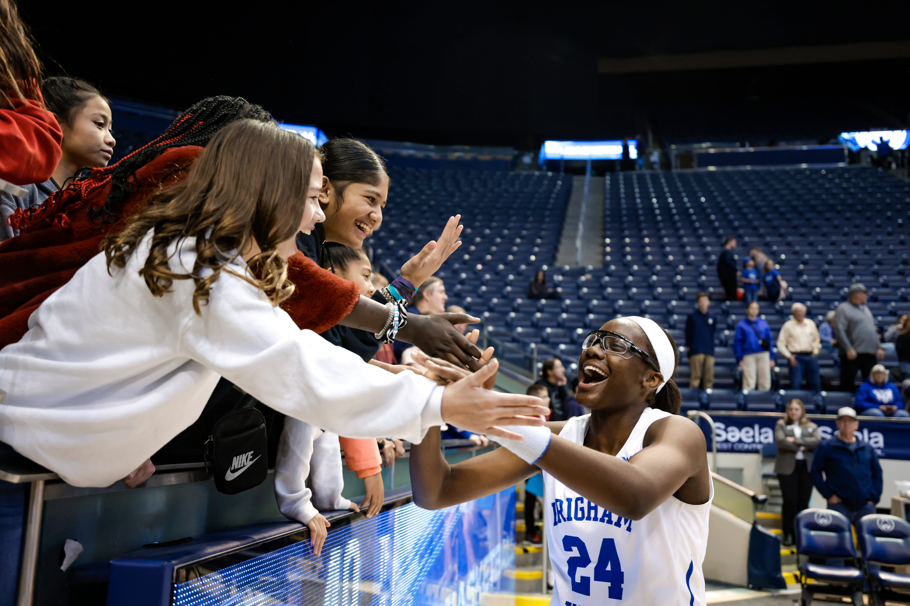 Rose Bubakar celebrates with the fans after a 63-49 win over San Diego.