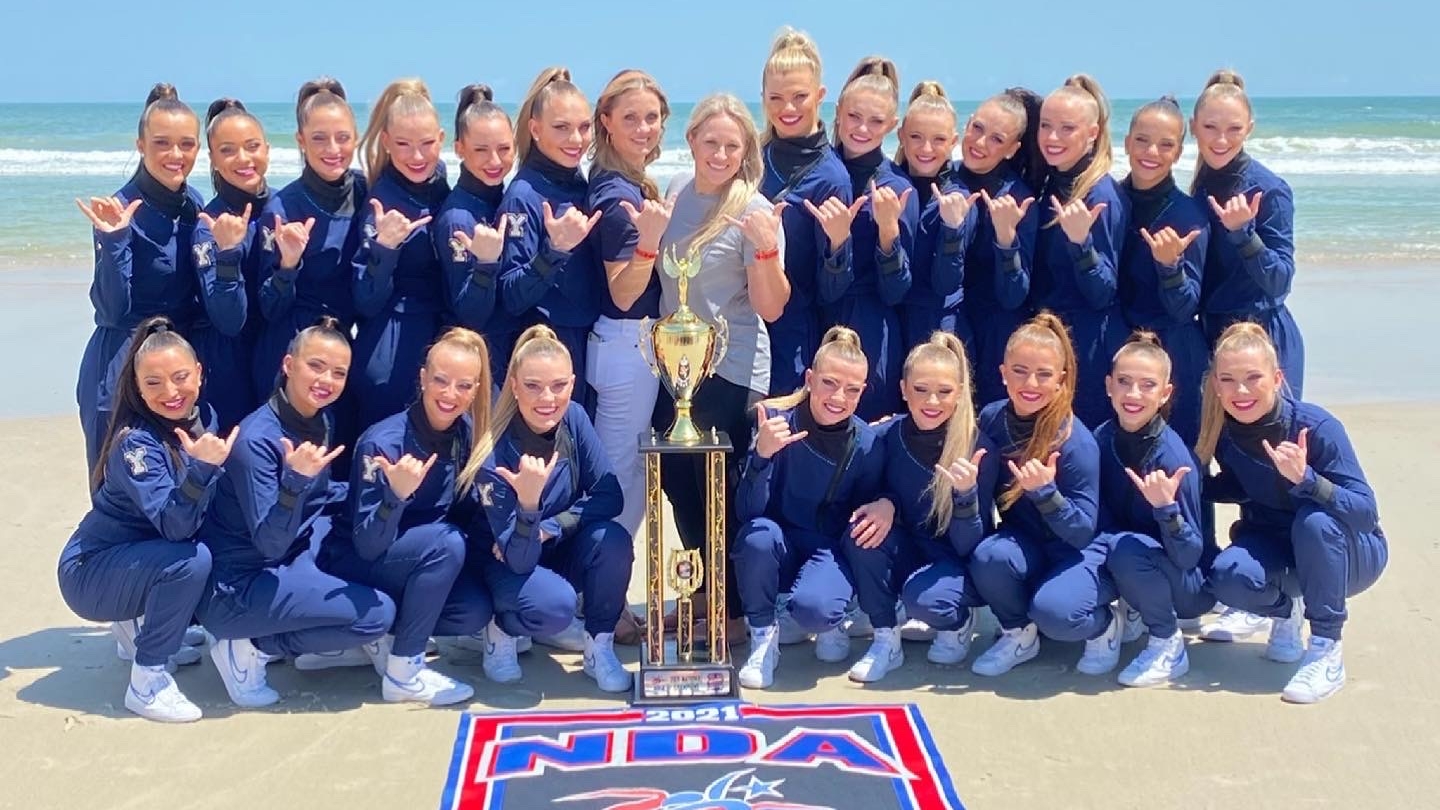 BYU Cougarettes with the NDA national championship trophy on the beach in Daytona, Florida