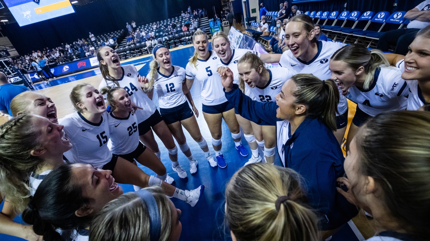 BYU women's volleyball team pre-game celebration in a circle