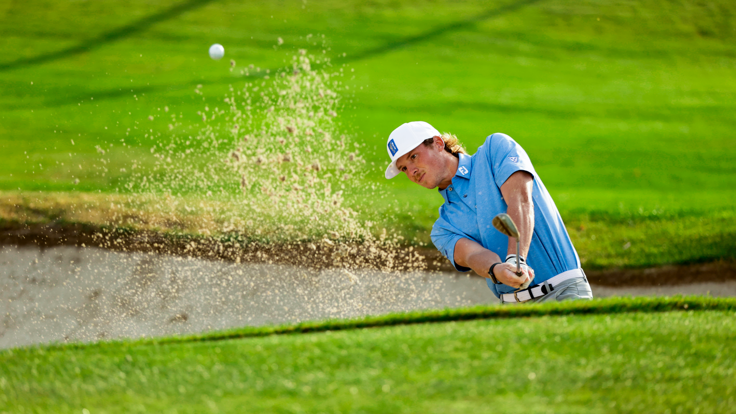 BYU golfer Carson Lundell hits a shot out of a bunker at Riverside Country Club.