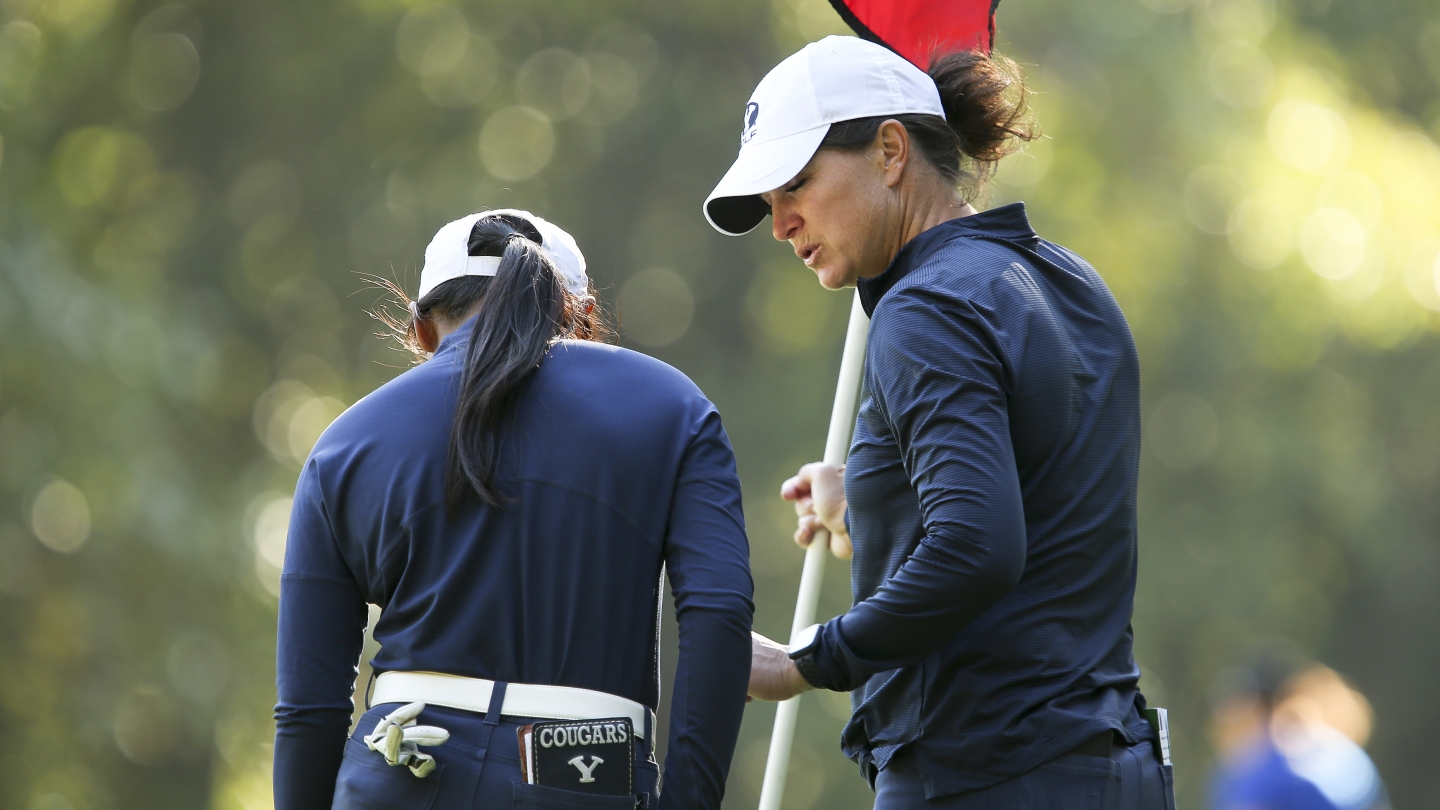 BYU women's golf head coach Carrie Roberts talks to Allysha Mae Mateo during the first round of the Dale McNamara Invitational (Tulsa Athletics)