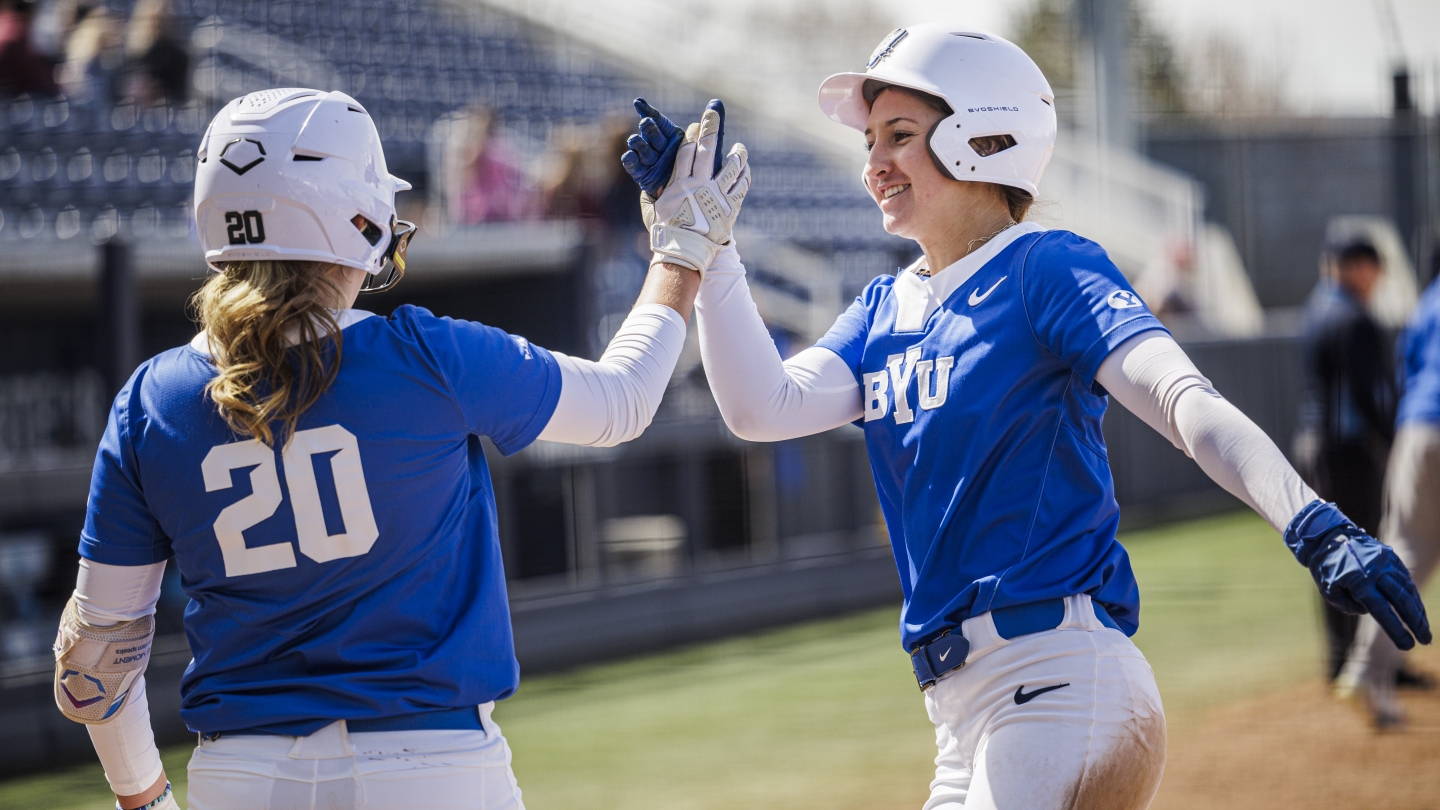 Alexis Gilio and Hailey Morrow high-five during game against Idaho State in Provo, Utah