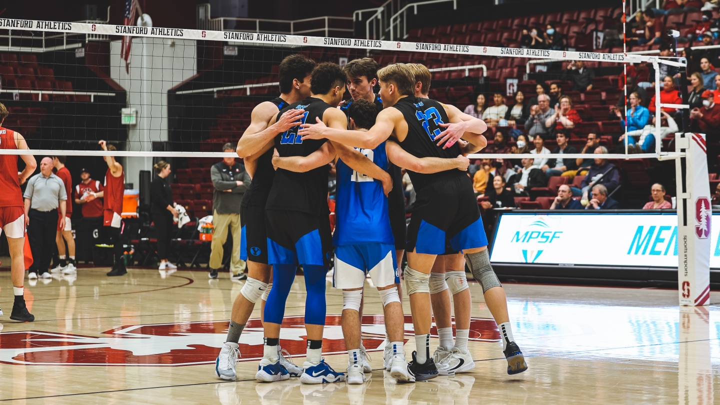 BYU men's volleyball players in a huddle in Maples Pavilion