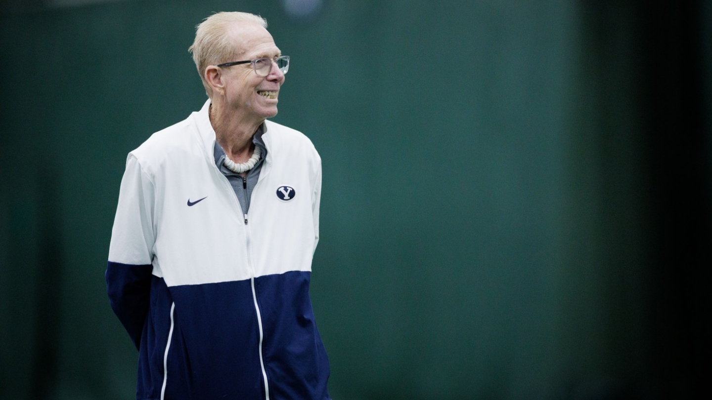 BYU men's tennis head coach Dave Porter smiles during a match at the BYU Indoor Tennis Courts