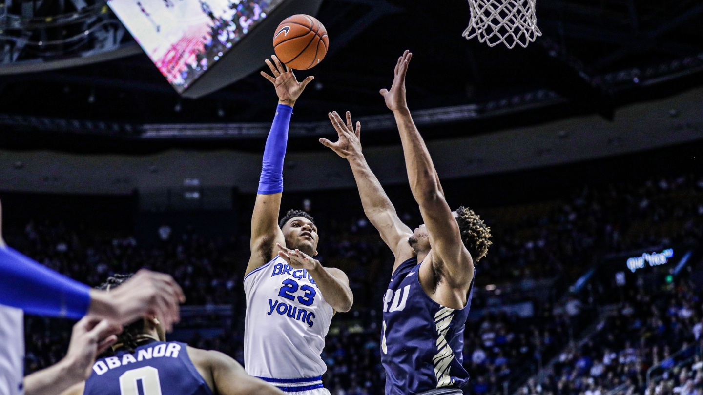 BYU men's basketball player Yoeli Childs shoots a hook shot over an Oral Roberts player at the Marriott Center