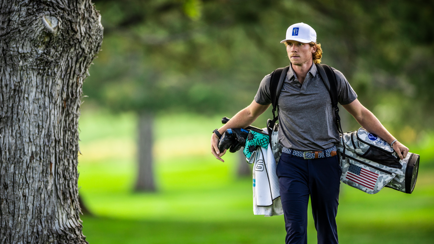 BYU golfer Carson Lundell walks past a tree at Riverside Country Club.