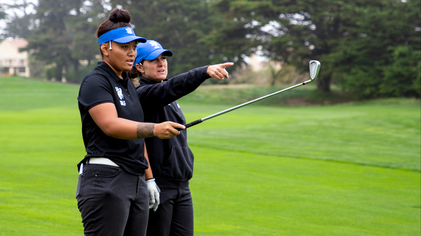 Carrie Roberts and Lila Galeai discuss how to hit a shot during the USF Intercollegiate. 